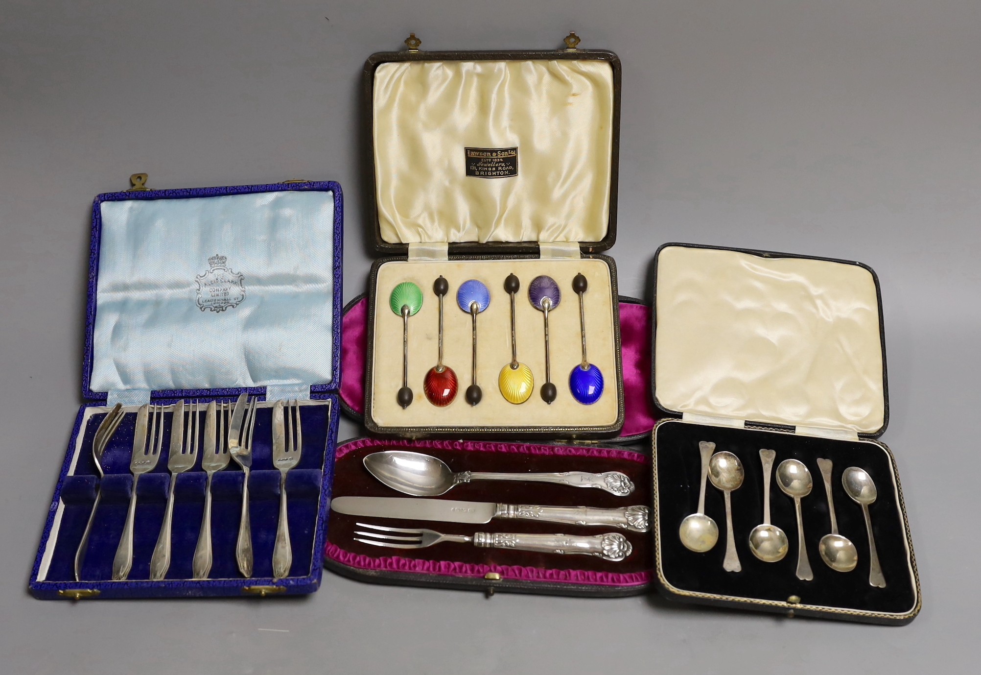 Four assorted cased sets of cutlery including a christening trio and a cased set of six silver and polychrome enamel, William Suckling Ltd. Birmingham, 1939.